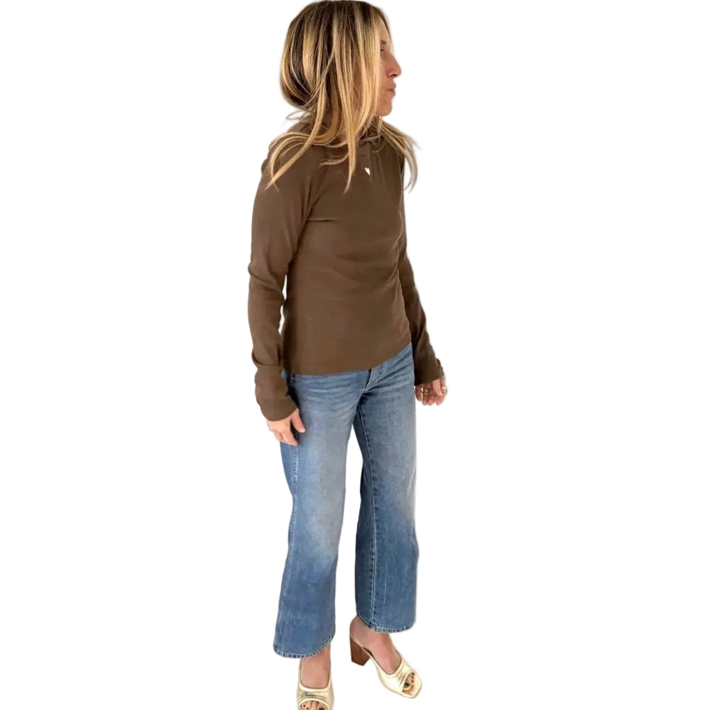 Side angle view of brown long sleeve ribbed crewneck tee with denim jeans and platform heel sandals.