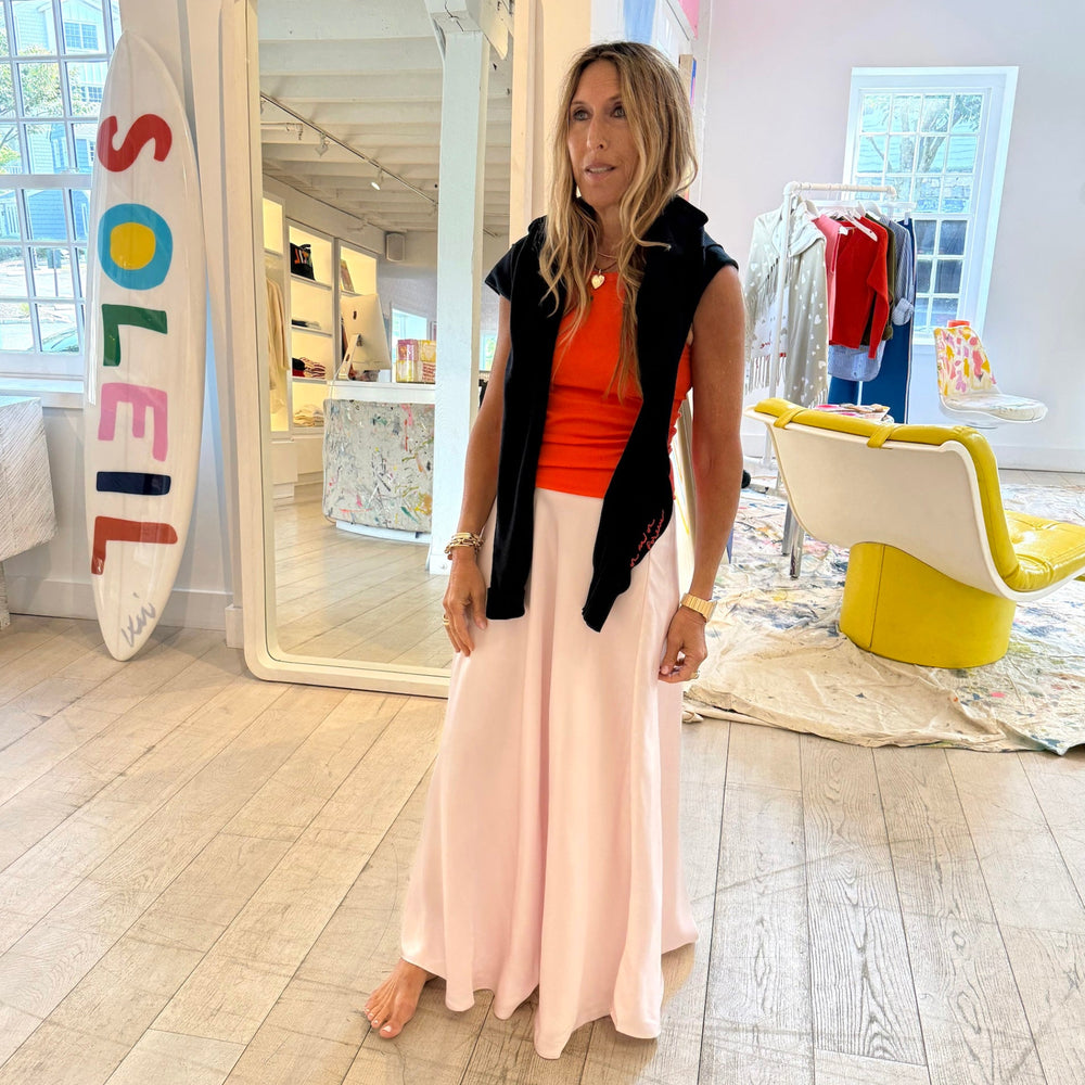 Navy blue caridgan layered over red top and blush pink maxi skirt, boutique lifestyle styling