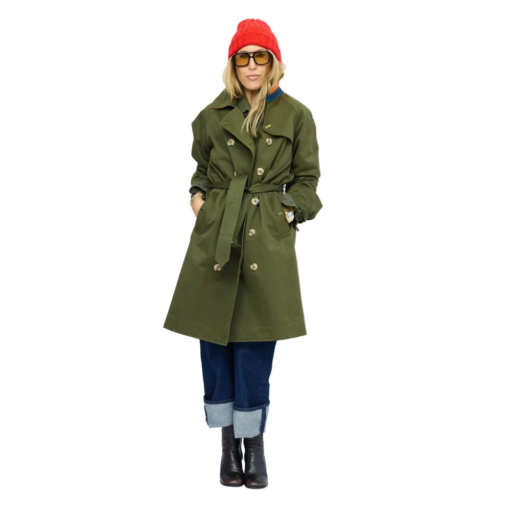 KR Trench Coat in olive green, double-breasted front view with contrast collar, styled with red beanie and cuffed denim jeans. Shop Kerri Rosenthal women's clothing.