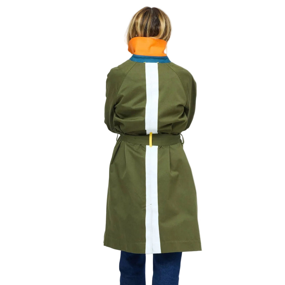 KR Trench Coat in olive green, back view showing white contrast stripe down center back and belted waist, styled with cuffed denim jeans. Shop Kerri Rosenthal jackets.