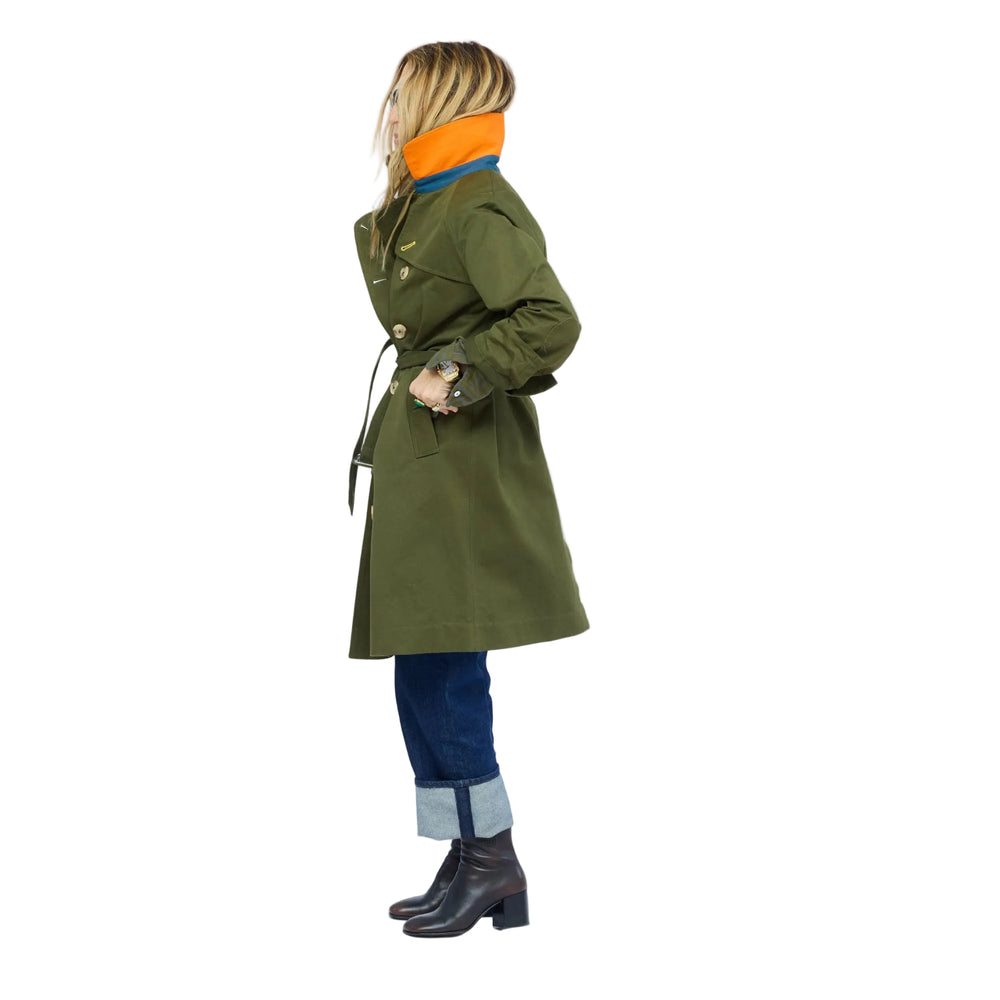 Side view of woman in KR Trench Coat in olive green, double-breasted front view with contrast collar and cuffed denim jeans
