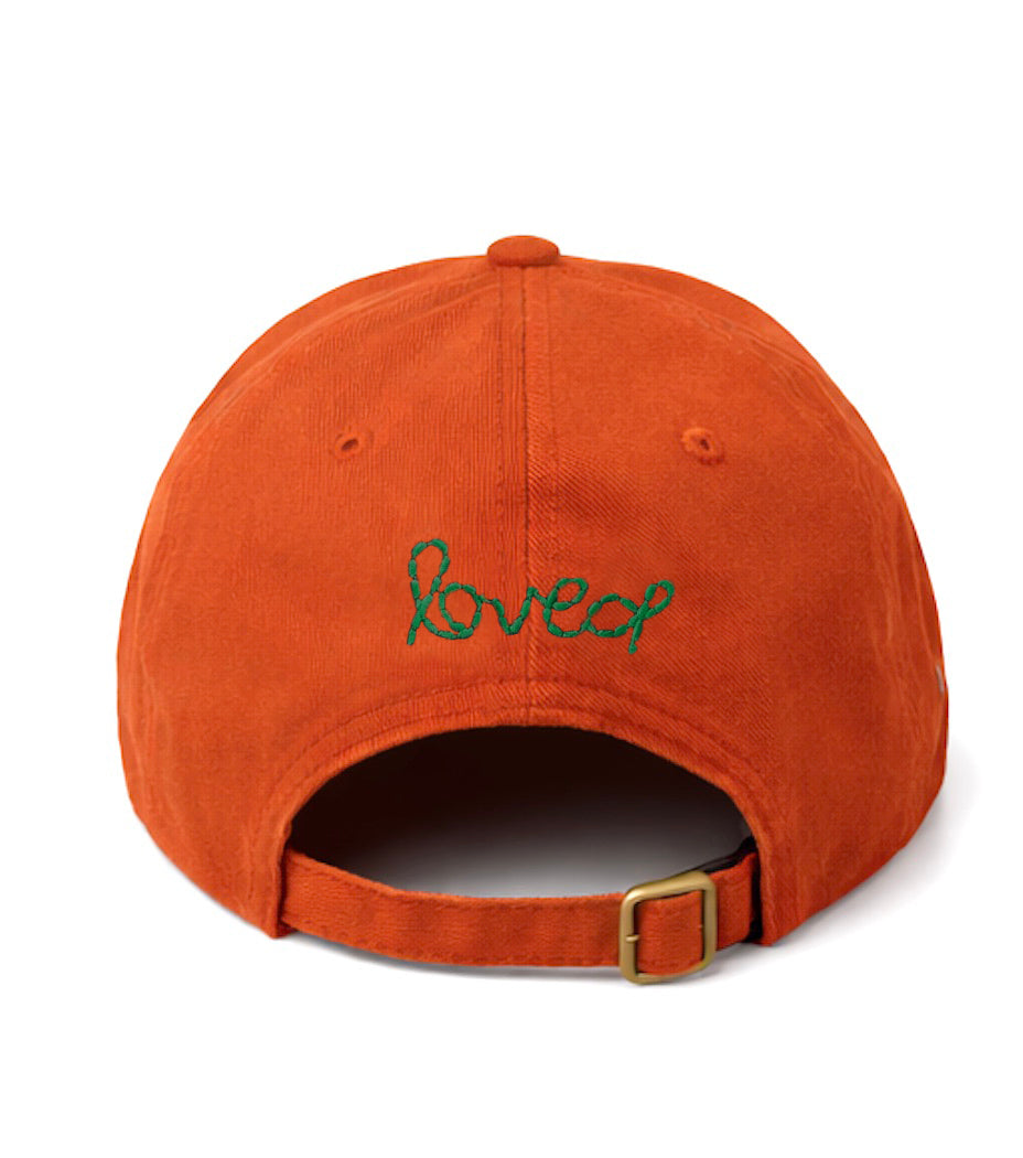 Kerri Rosenthal Imperfect Heart baseball cap in orange with loved stitched in green on back.