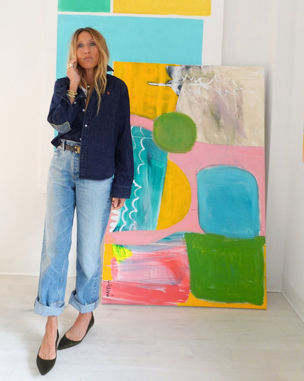 Kerri Rosenthal dark denim button-down shirt, front view styled with cuffed jeans and gold heeled sandals