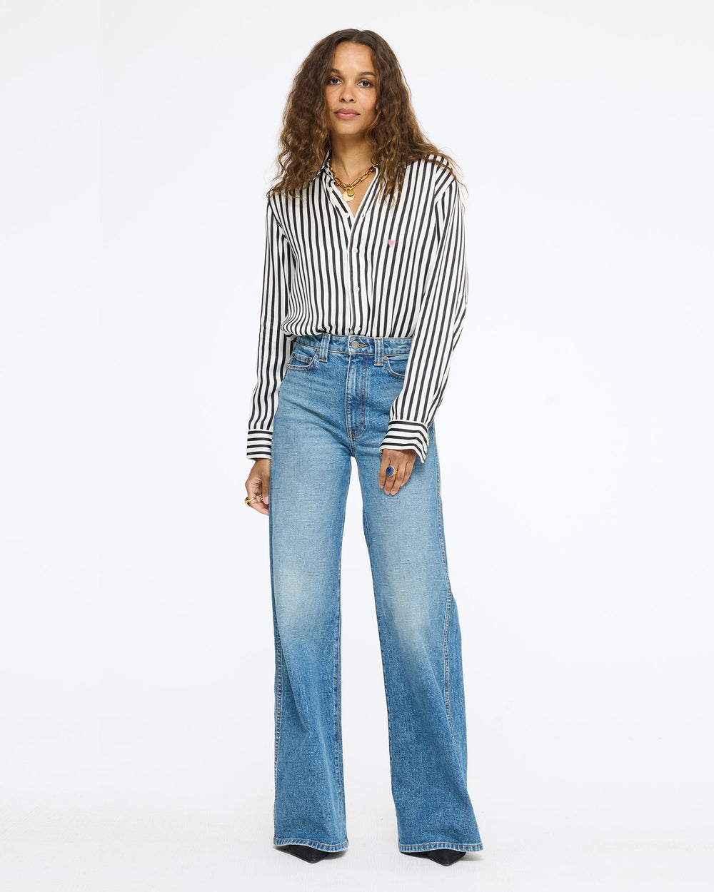 Model wearing the Keaton Stripe Shirt in cream and black stripe with wide-leg jeans, full length front view