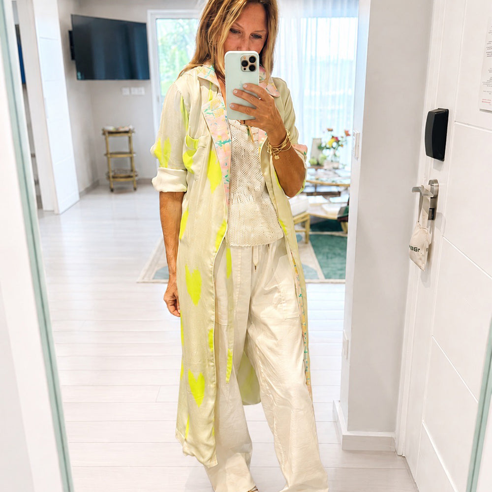 Women's cream and neon lime green heart print maxi duster coat with pink floral contrast trim. Shop Kerri Rosenthal.