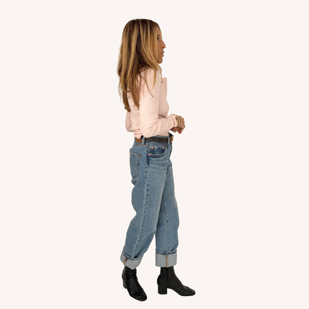 Kerri Rosenthal blush pink rib henley, side profile view styled with jeans and black boots