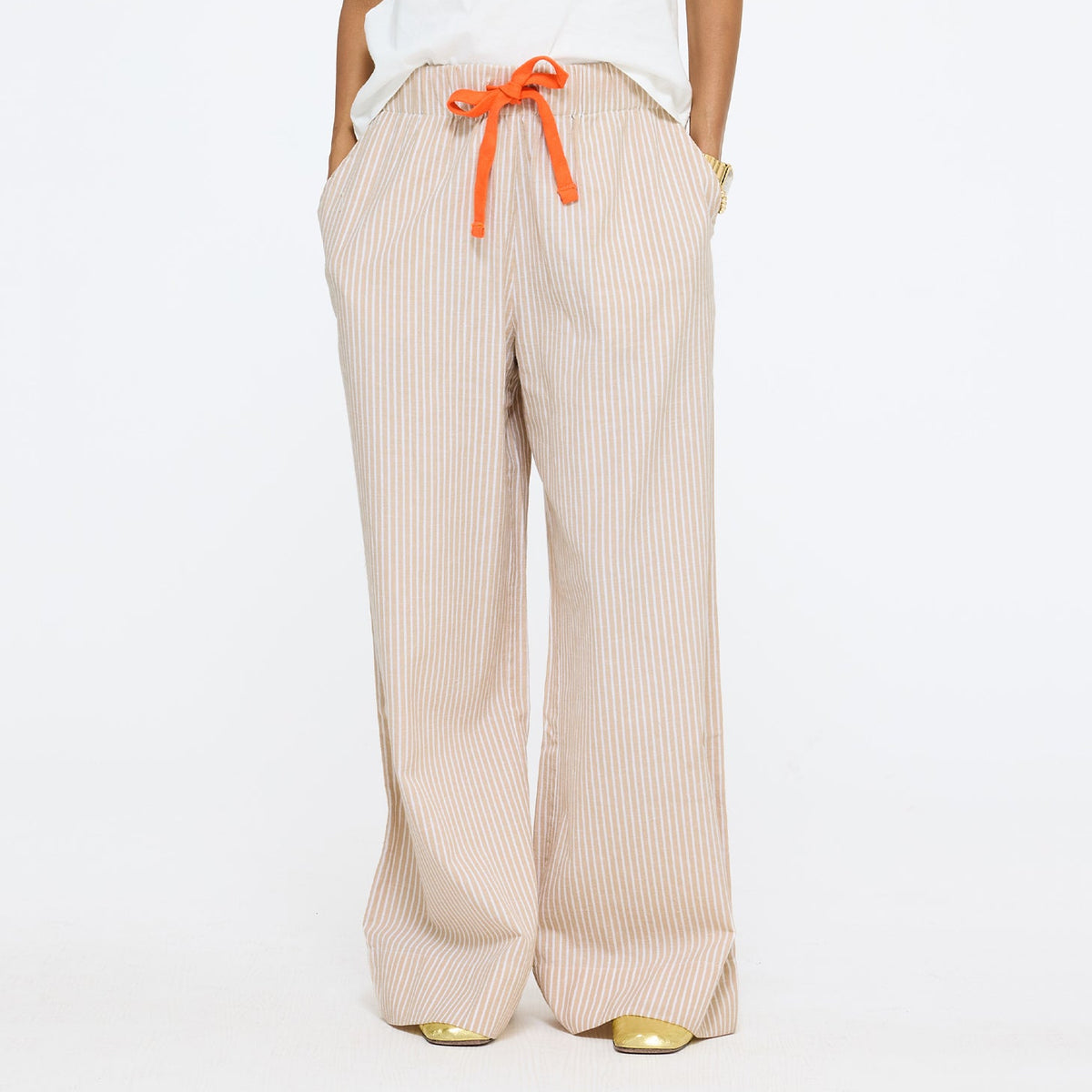 Beige pants for ladies in cotton linen with pockets. Shop women's cute trouser pants by Kerri Rosenthal.