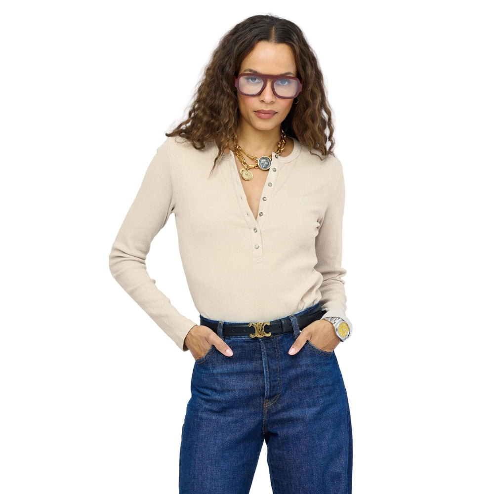 Kerri Rosenthal ivory ribbed henley with buttons at center front, worn with jeans, hands in pockets