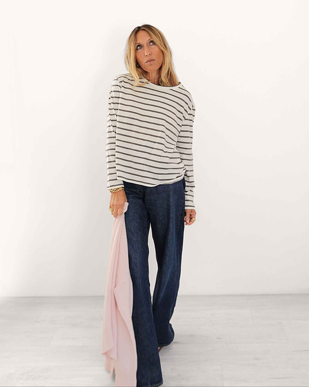 Kerri wearing the KR Long Sleeve Tee in White-Gray, styled with dark jeans