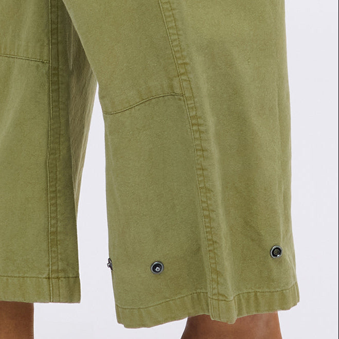Close-up of army green pants showing the cuff detail with grommet eyelets.