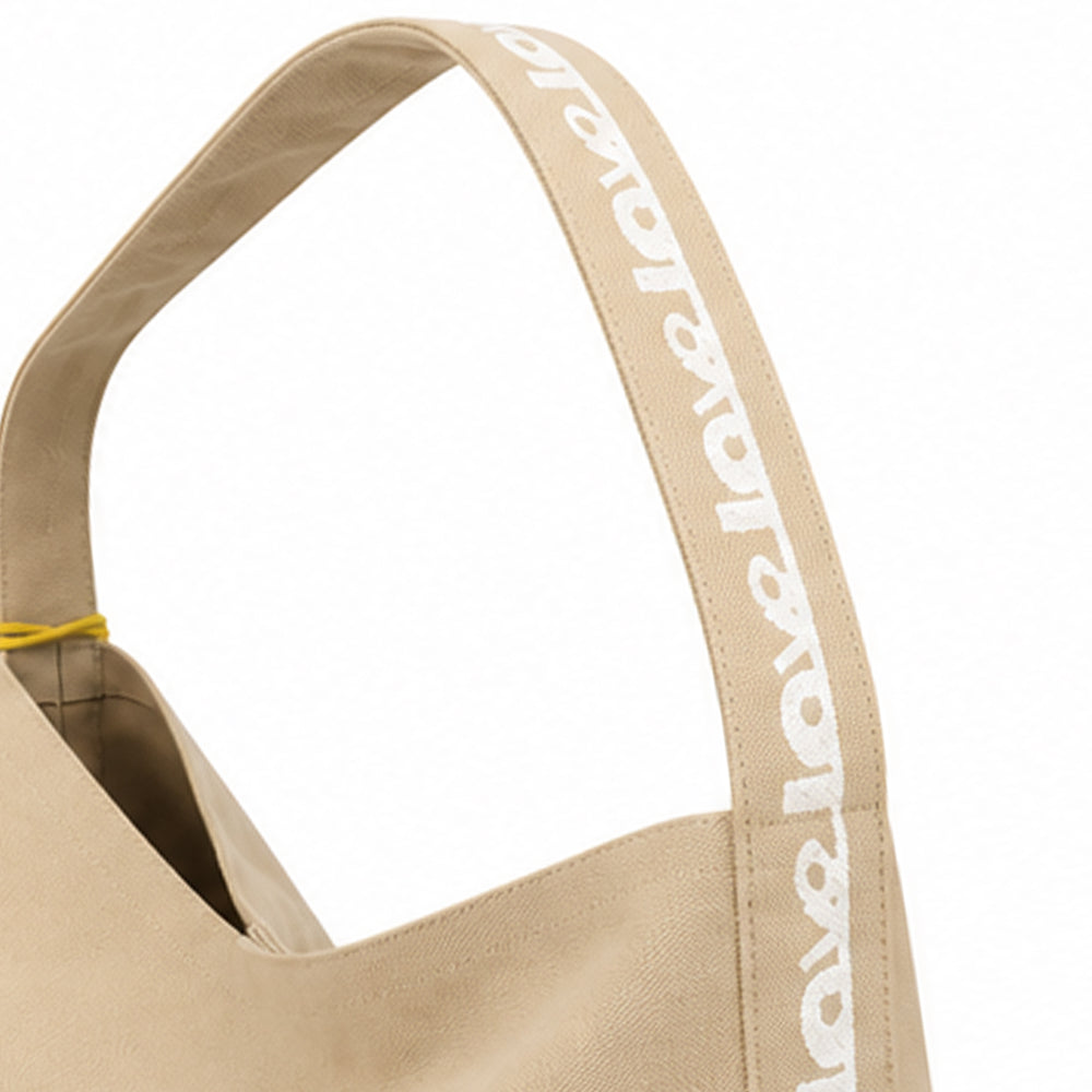 beige hobo bag with white heart on center.