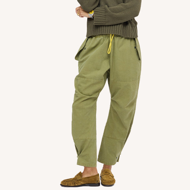 Close-up army green yellow drawstring pants with an olive top and tan suede loafers. Shop women's pants at Kerri Rosenthal