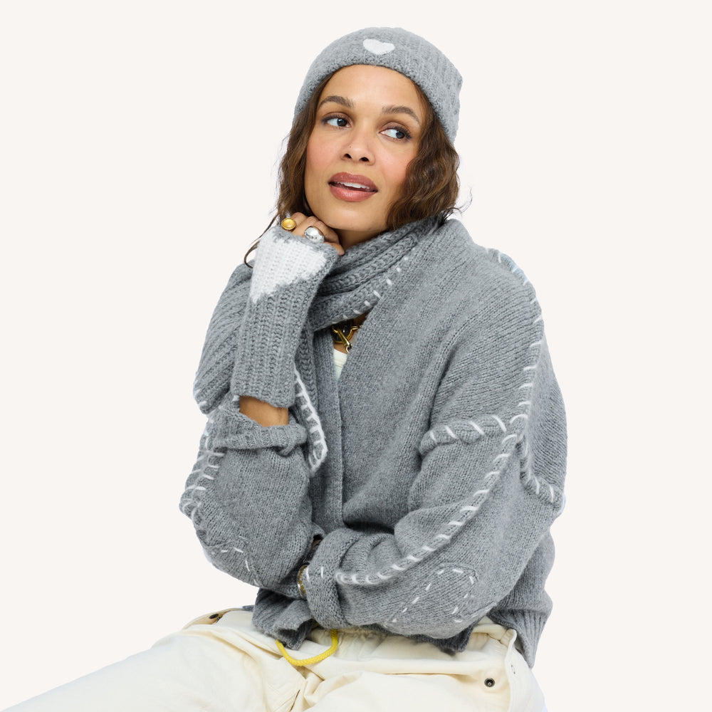 Model wearing grey ribbed Cashmere Beanie paired with Loved Cashmere Smittens and Loved Loop Scarf.