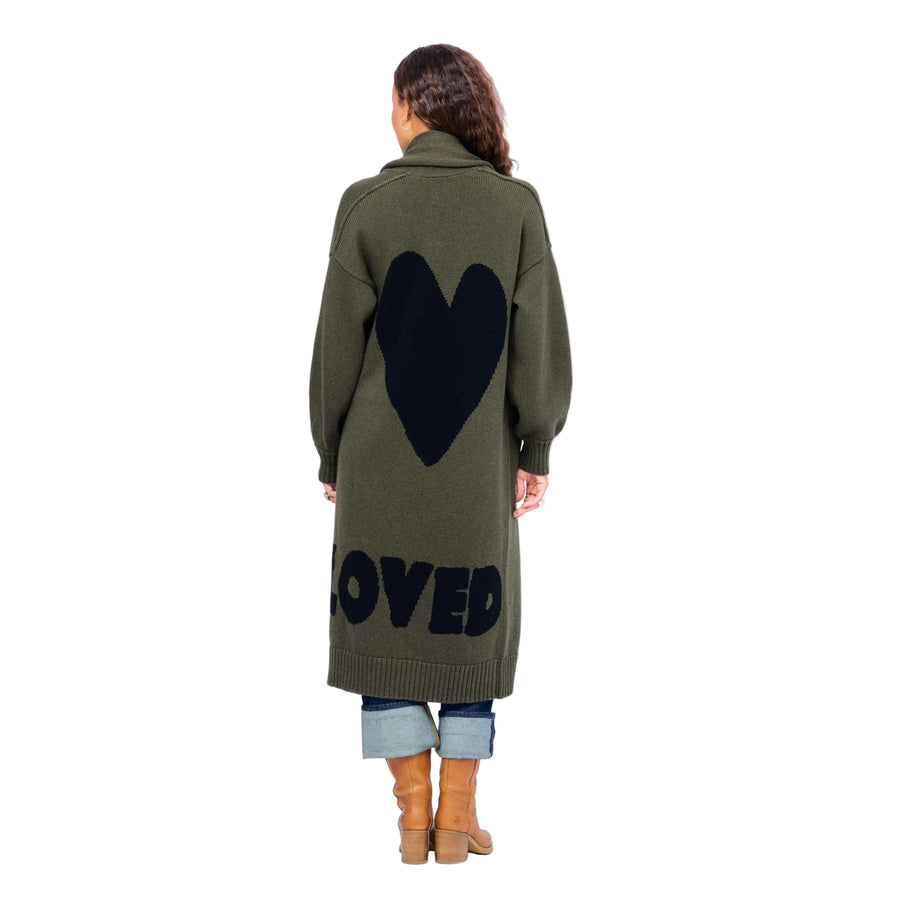 Model wearing Mercer Loved Duster in army green with black heart and "loved" design in back.