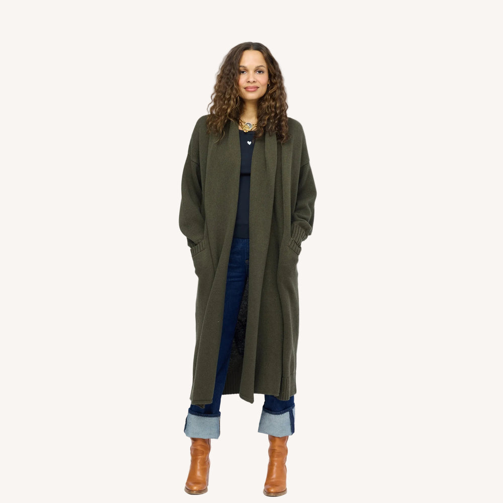 Model wearing Mercer Loved Duster in army green, hands in pockets.