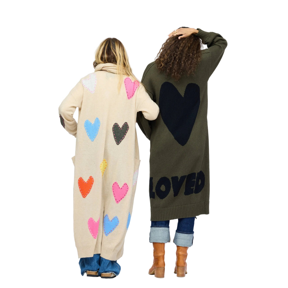 Model wearing Mercer Loved Duster in army green with black heart and "loved" design in back. Kerri wearing Super Duper Zero Waste Duster.