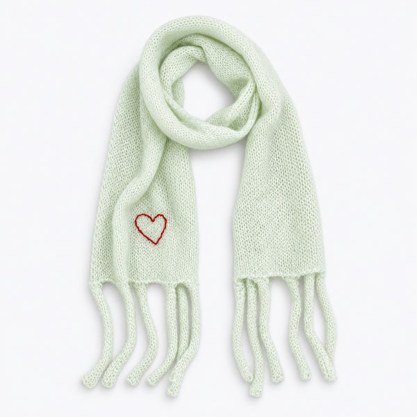 Flat view of the Cloud Hopping Scarf in pistachio with fringe ends and a red embroidered heart