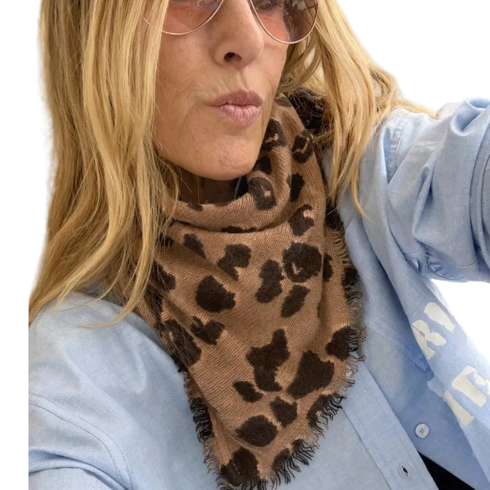 Kerri Rosenthal leopard print bandana worn tied around the neck over a denim jacket