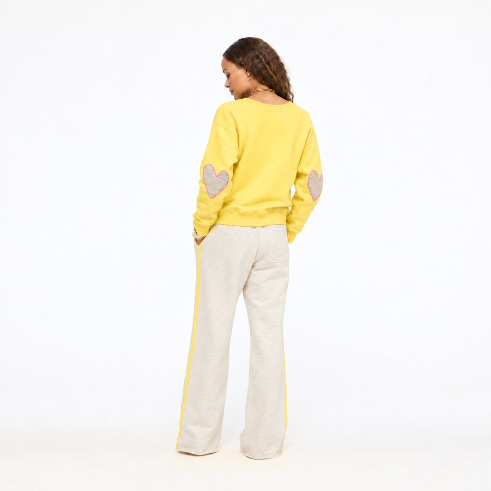 Model wearing the Super Soft Fleece Weekend Palazzo in taupe heather with the Mad Love Mock Neck Sweater in golden yellow, full length back view