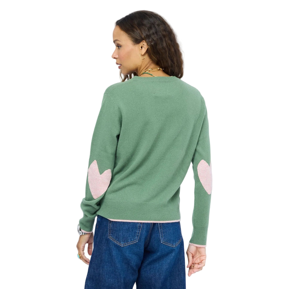 Back view of green cashmere crewneck sweater showing pink heart patches on both elbows