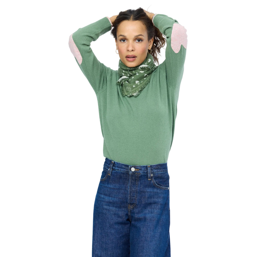 Kerri Rosenthal olive heart-print bandana worn as a headscarf, styled with a green sweater and jeans