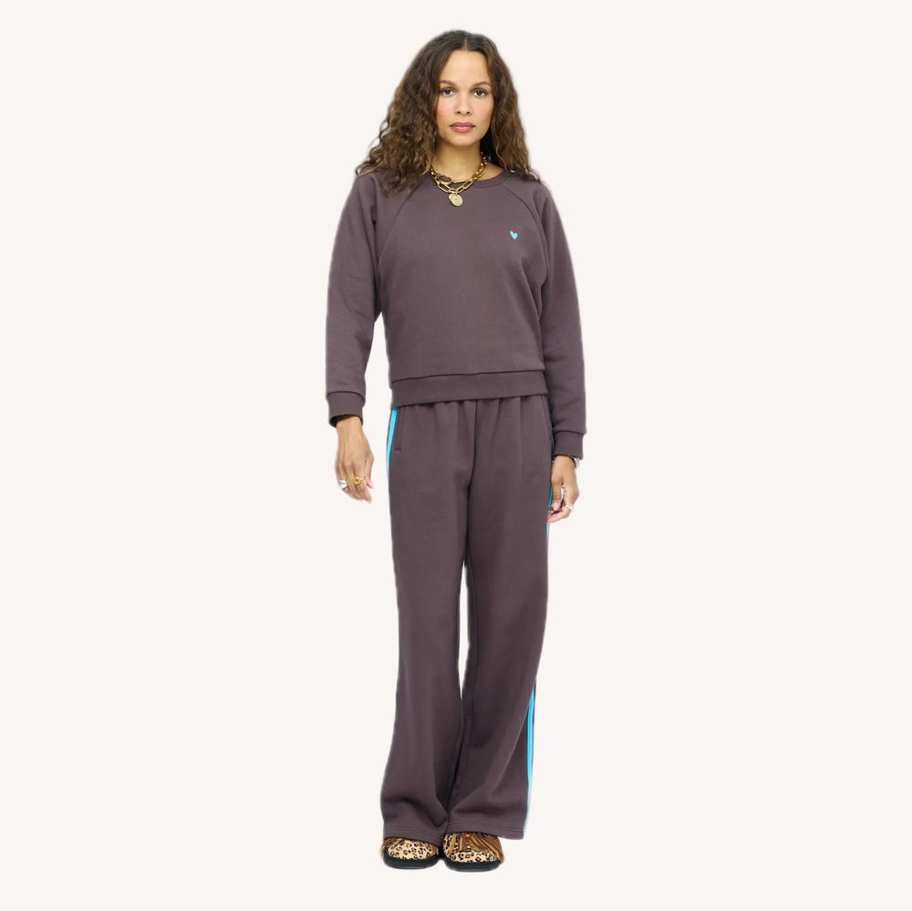Model wearing True Sweatshirt in Cocoa with light blue heart embroidered on chest, styled with Super Soft Fleece Weekend Palazzo.