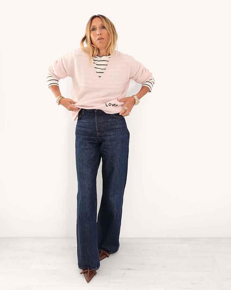 Kerri wearing the KR Long Sleeve Tee in White-Gray, styled with Saturday Cashmere sweater and dark jeans
