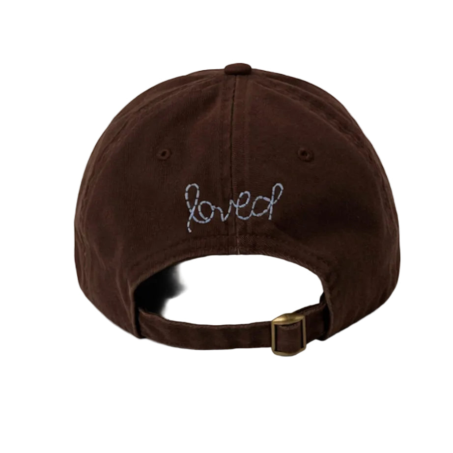 Back view of Kerri Rosenthal Imperfect Heart baseball cap in brown with blue 'loved' embroidery