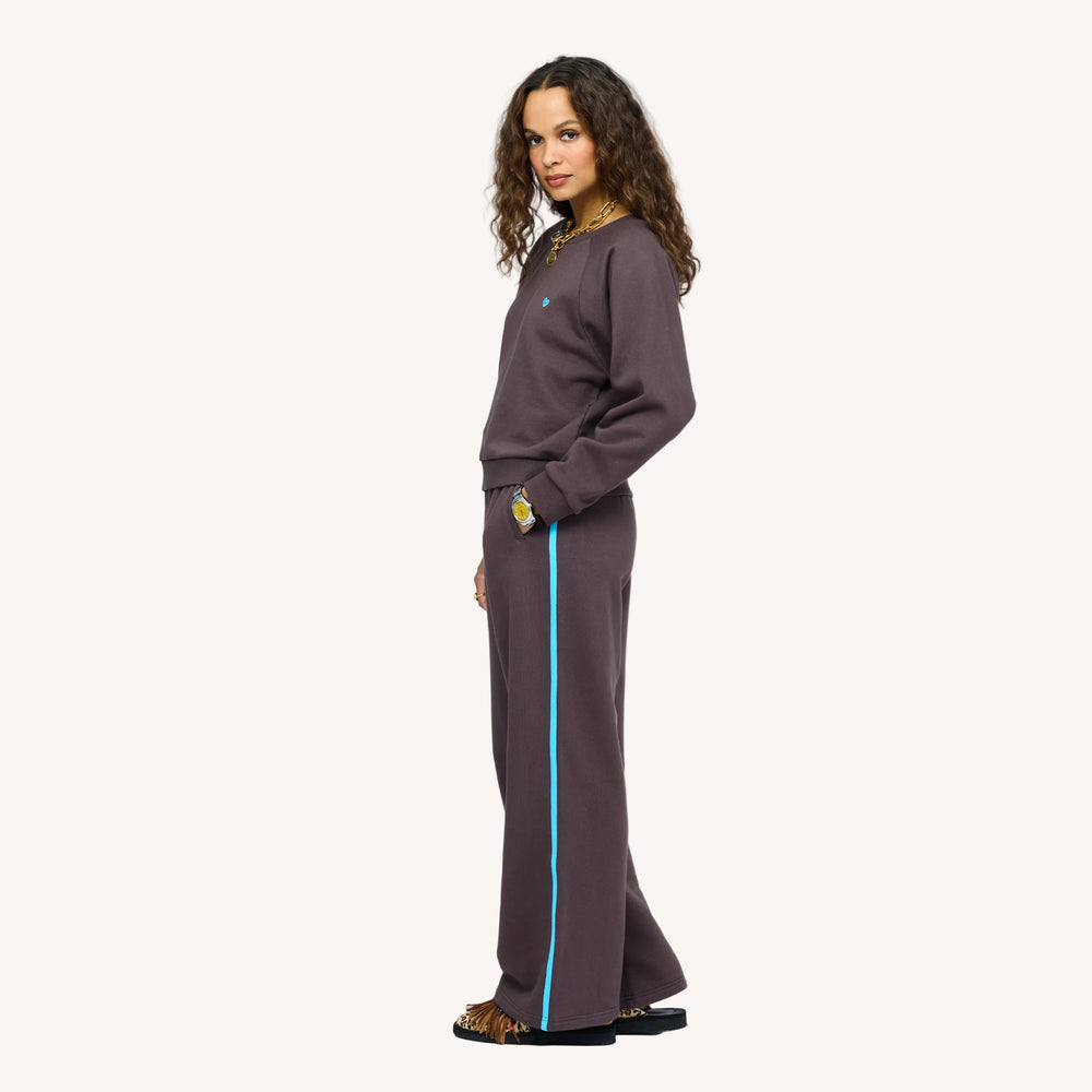 Model wearing True Sweatshirt in Cocoa with light blue heart embroidered on chest, styled with Super Soft Fleece Weekend Palazzo, side view.