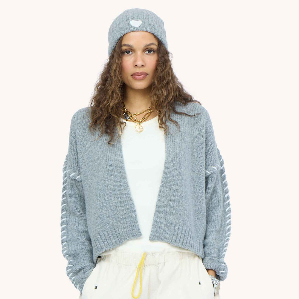 Model wearing Sienna Cardigan in Smoke gray, styled with light Love Brigade Pants and grey beanie