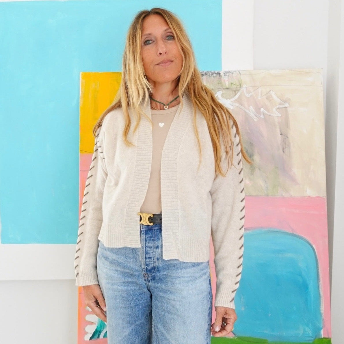 Kerri Rosenthal ivory sweater front view, with stitching  styled with jeans 