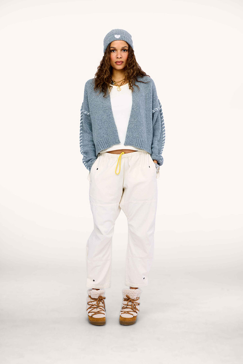 Model wearing Sienna Cardigan in Smoke gray, styled with light Love Brigade Pants and grey beanie