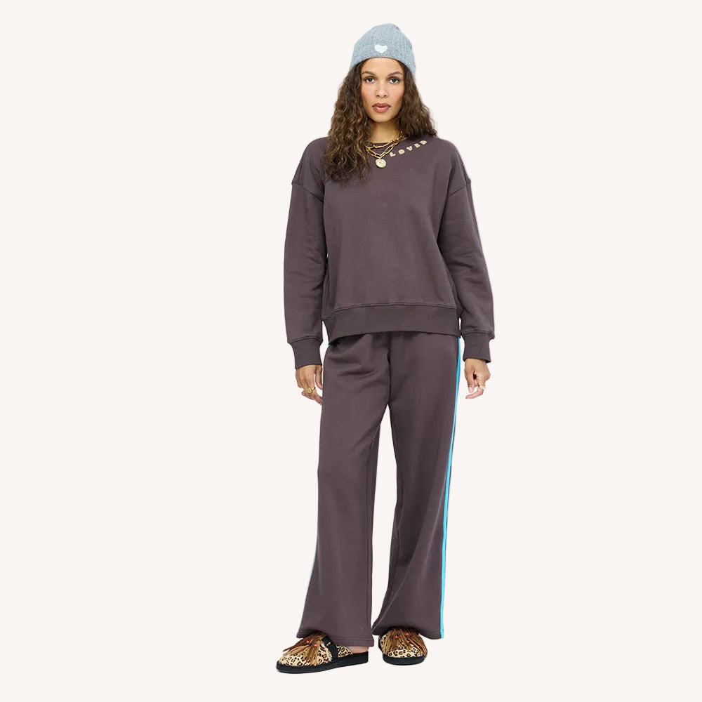 Model wearing  Weekend Palazzo Sweatpant wide-leg trouser with a sporty stripe down the leg, front view.