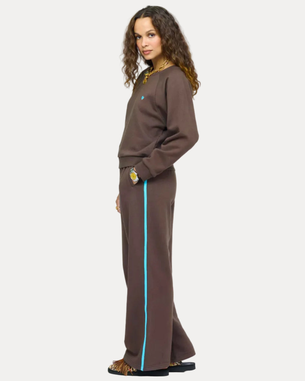 Model wearing True Sweatshirt in Cocoa with light blue heart embroidered on chest, styled with Super Soft Fleece Weekend Palazzo, side view.