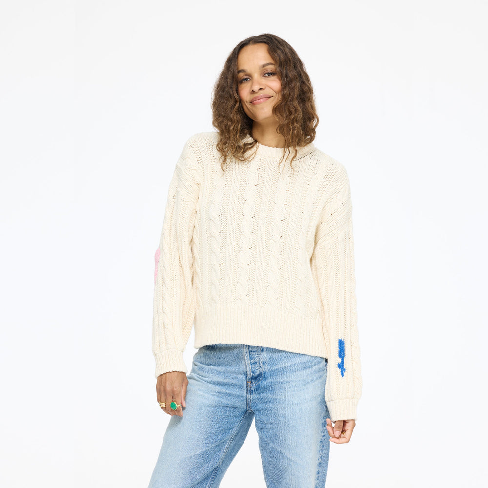 Model wearing the Rocky Patchwork Sweater in cream with jeans, front view