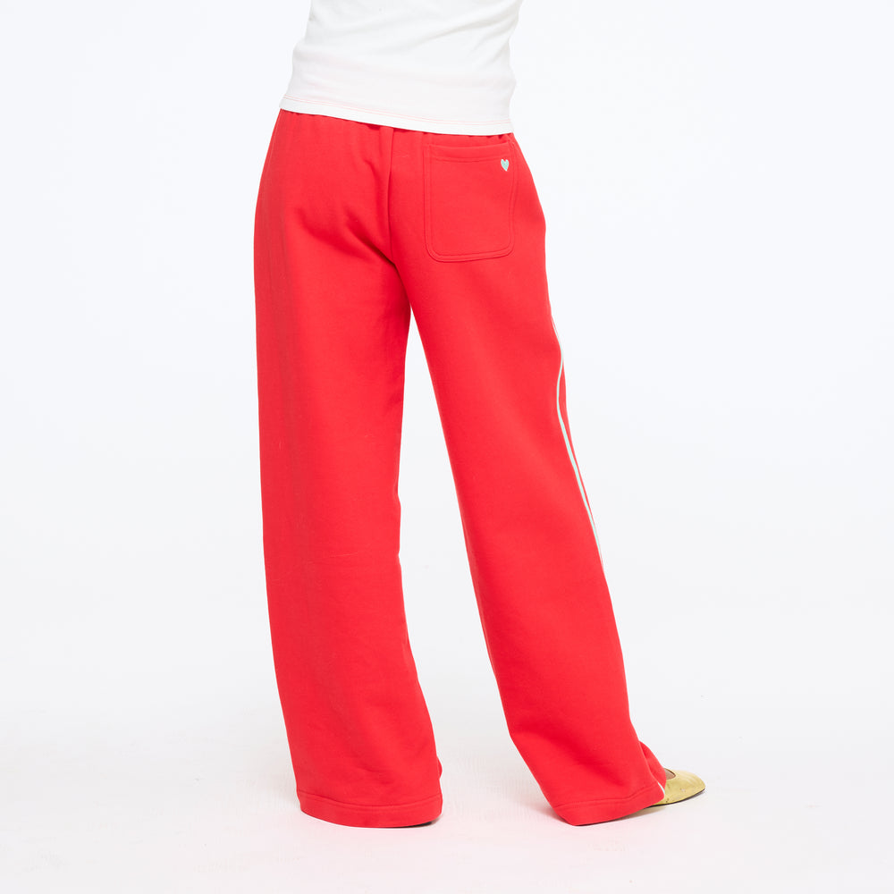 Waist-down view of the Super Soft Fleece Weekend Palazzo in red showing the white side stripe and wide leg