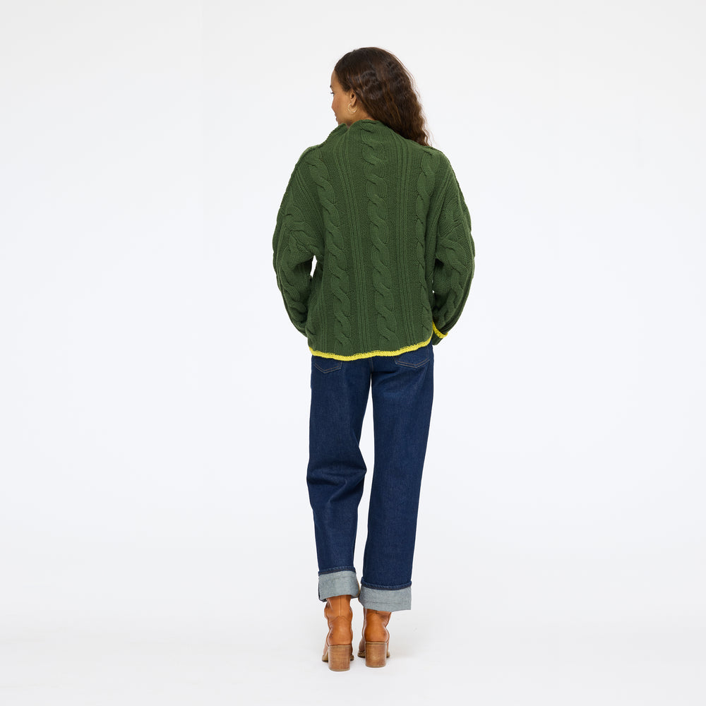 Model wearing the Hearth Sweater in spruce with jeans, back view