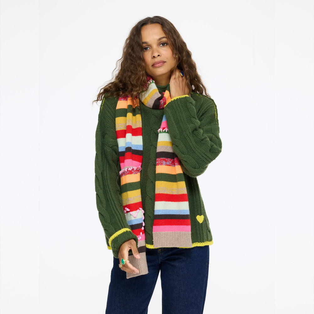 Model wearing the Hearth Sweater in spruce with the Fireside Scarf and jeans, front view