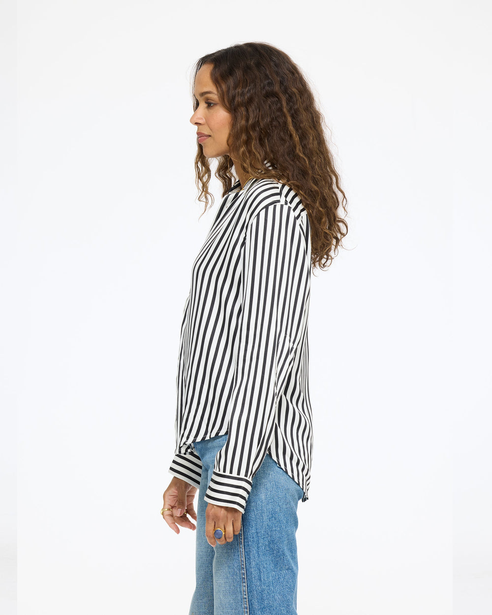 Model wearing the Keaton Stripe Shirt in cream and black stripe with jeans, side view