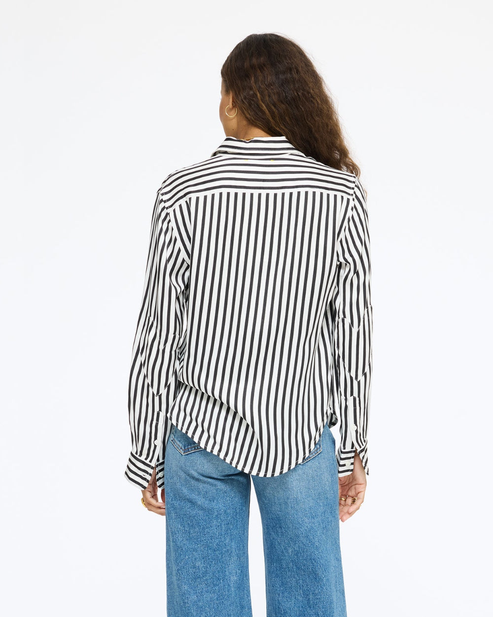 Model wearing the Keaton Stripe Shirt in cream and black stripe with jeans, back view