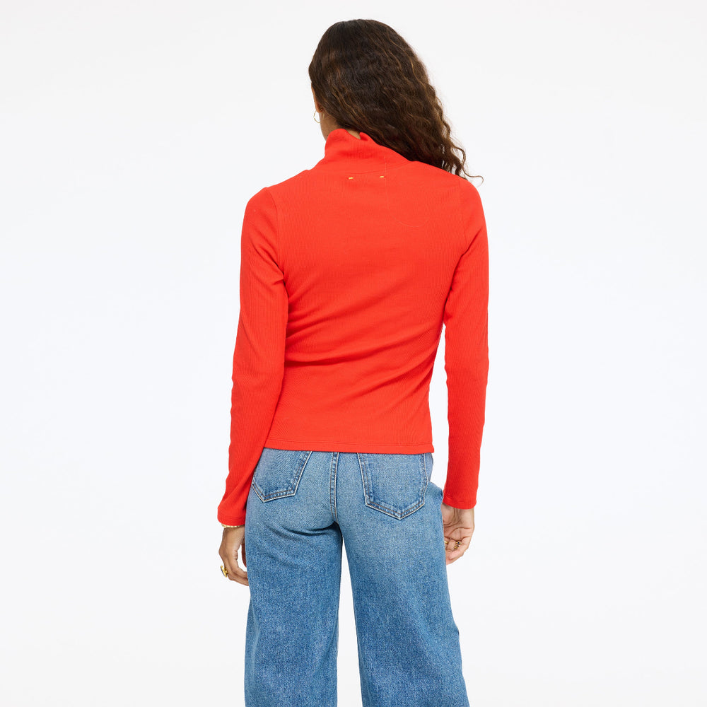 Model wearing the Mock Neck Rib Tee in red with jeans, back view
