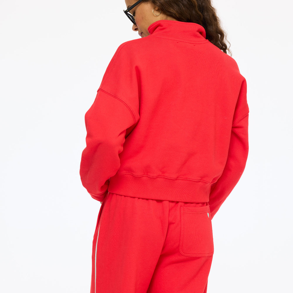 Model wearing the Sunday Quarter Zip Sweatshirt in red with the Super Soft Fleece Weekend Palazzo in red, back view