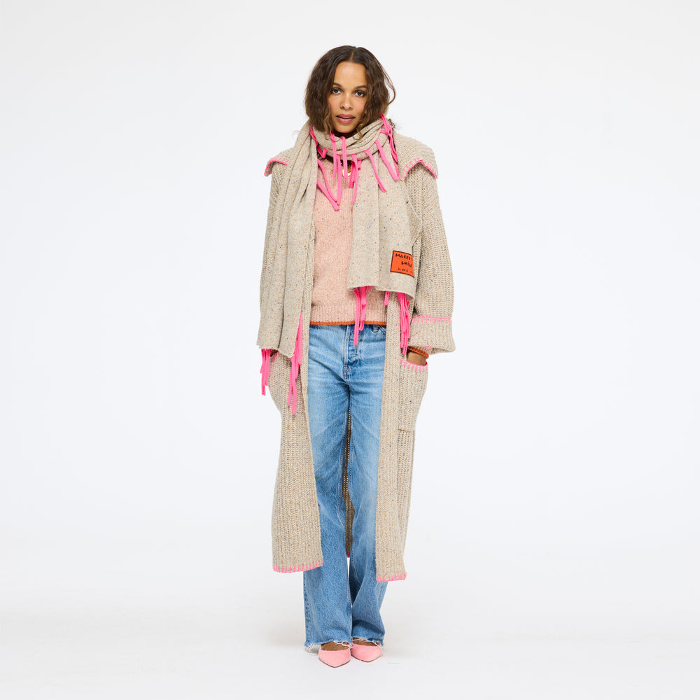 Model wearing the Morning Coffee Duster in oatcake with the Makes You Smile Scarf, a white top, and jeans, full length front view