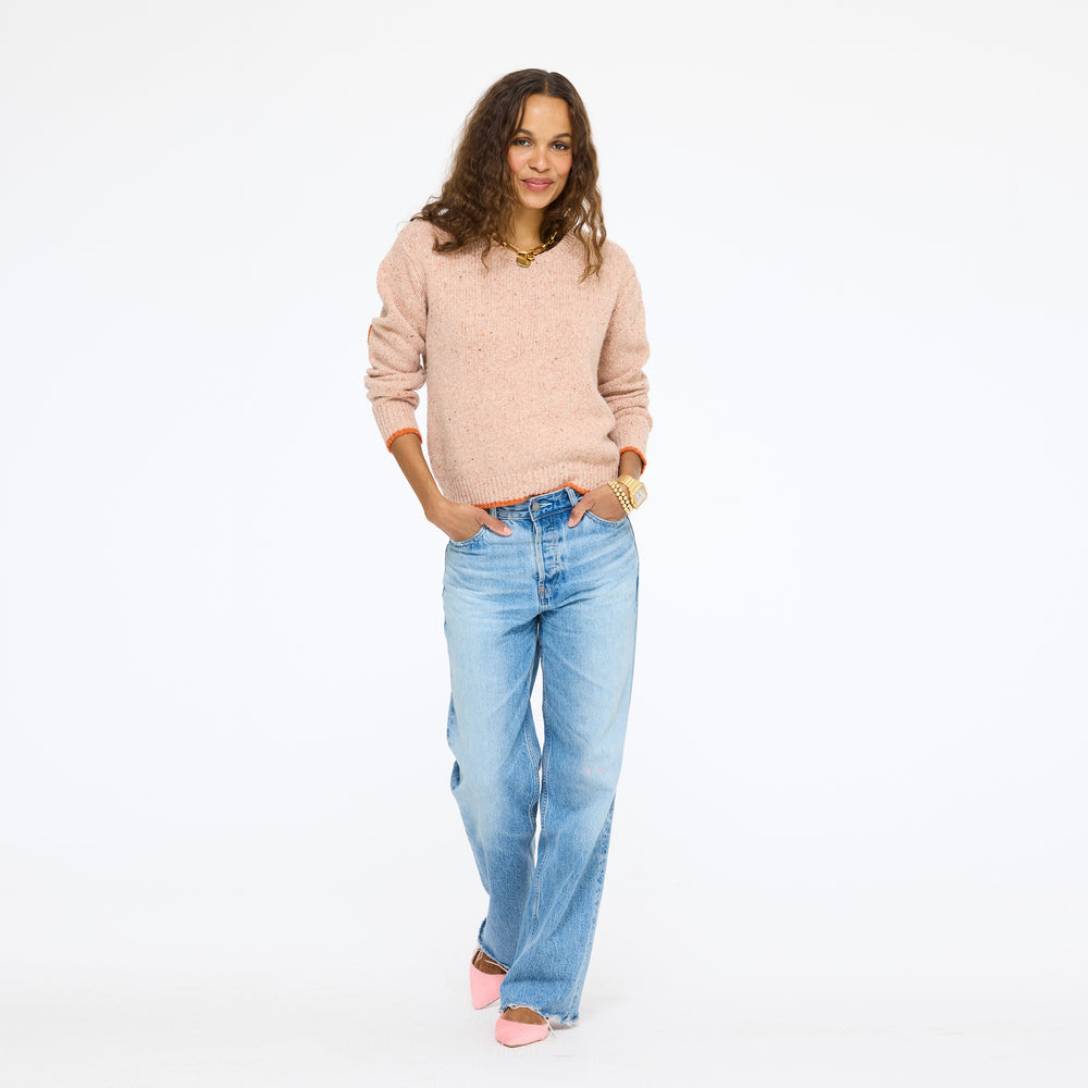 Model wearing the Patchwork Pullover Sweater in blush with jeans, full length front view