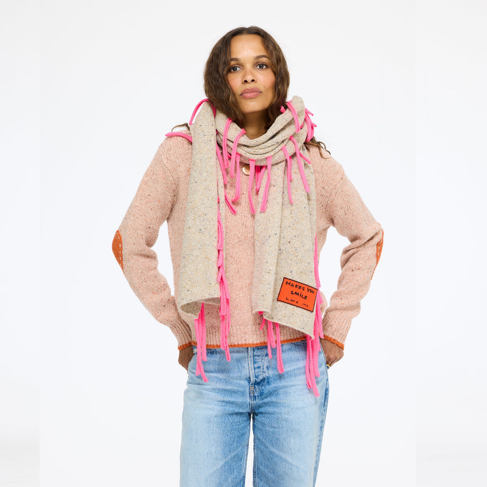Model wearing the Makes You Smile Scarf in oatcake over the Patchwork Pullover Sweater in blush with jeans, front view