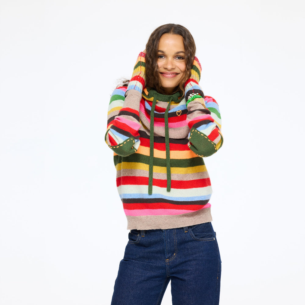 Model wearing the McLuvin Hoodie in multicolor stripe over the Patchwork Pullover Stripe Sweater with jeans, front view