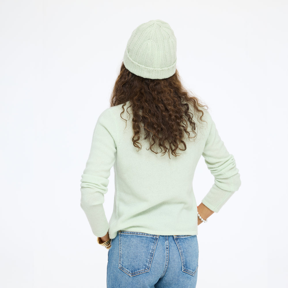 Model wearing the Winter Beanie in pistachio with the Pixie Sweater in pistachio and jeans, back view