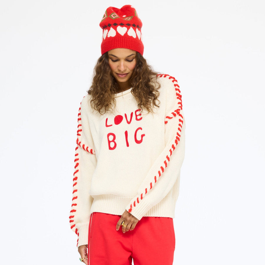 Model wearing the Love Big Sweater in cream with the Super Soft Fleece Weekend Palazzo in red and the Rosey Beanie, full length front view