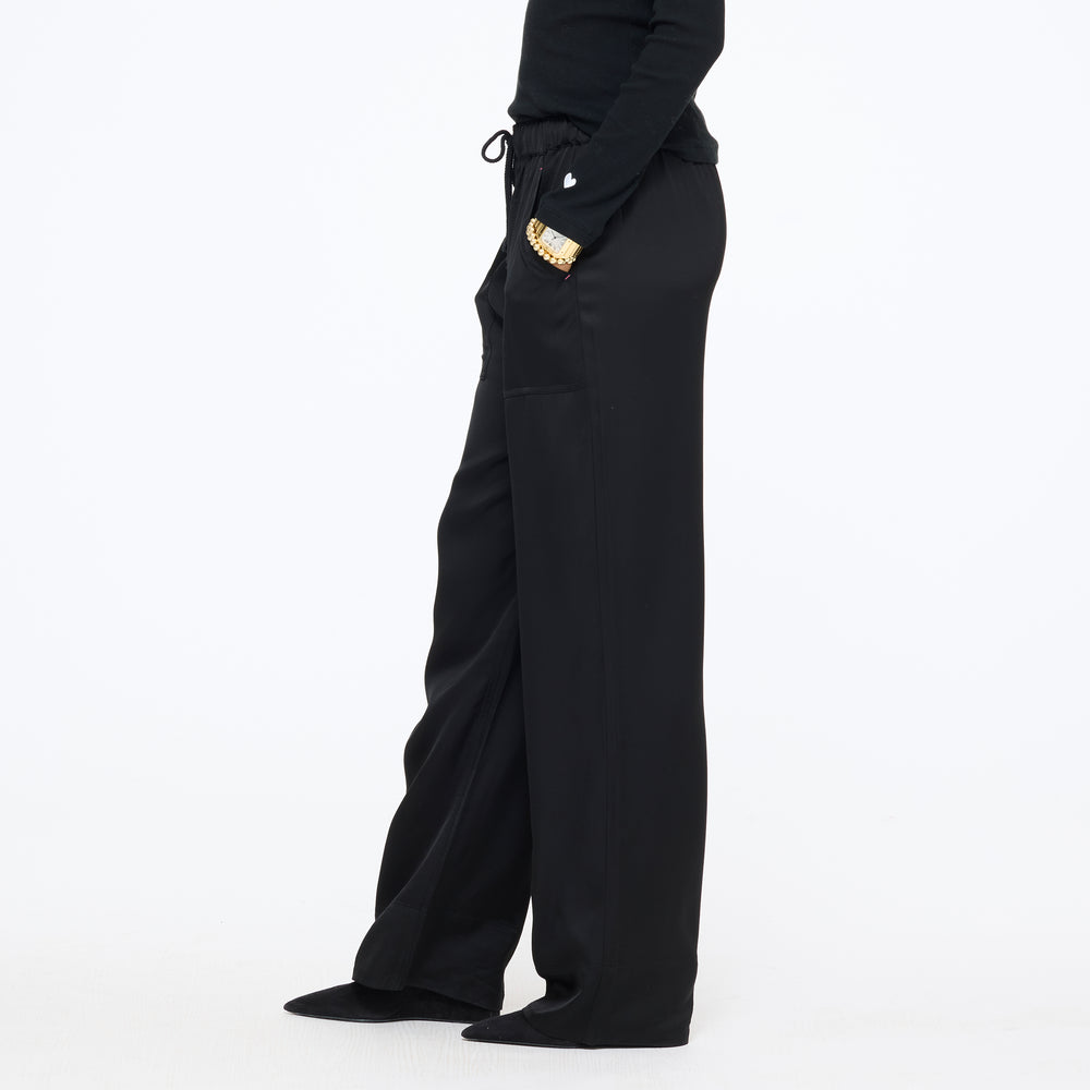 Waist-down side view of the wide-leg Coast Pant in black