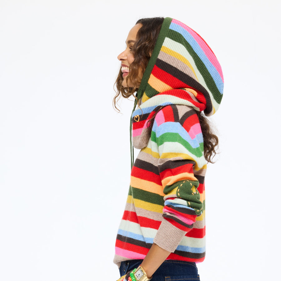 Model in side profile wearing the McLuvin Hoodie in multicolor stripe with the hood up over the Patchwork Pullover Stripe Sweater